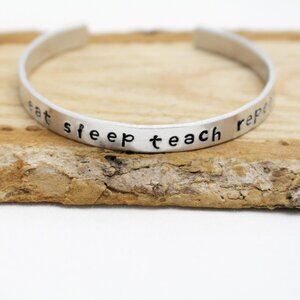 Eat Sleep Teach Repeat - Hand Stamped Anodized Aluminum Bangle - Adjustable